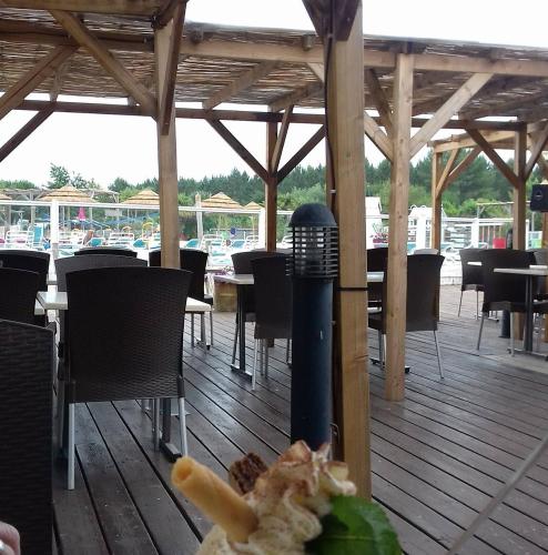 un restaurant avec des tables, des chaises et une table avec de la nourriture dans l'établissement Rêve en Famille, à Gastes