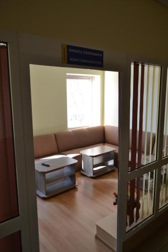a living room with a couch and a table at Maverick in Ternopilʼ