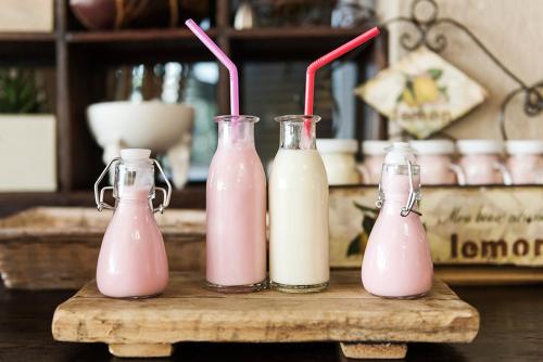 three bottles of pink drinks on a wooden table at Glenda's Guest Suites in Midrand