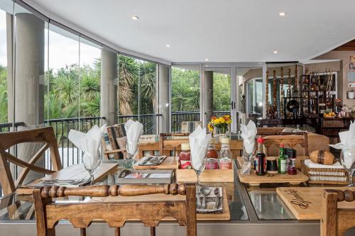 a dining room with a glass table and chairs at Glenda's Guest Suites in Midrand