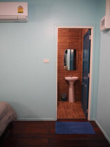 a bathroom with a sink and a toilet in a room at Baantantara in Suan Phung