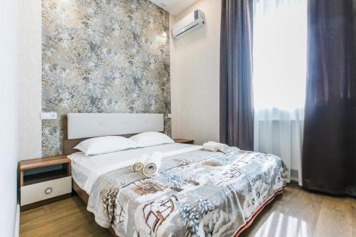 a bedroom with a bed with two towels on it at Sweet Home 6 VIP at Rustaveli Avenue in Tbilisi City