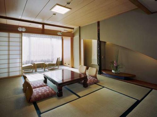 a living room with a coffee table and chairs at Kinparo in Kyoto