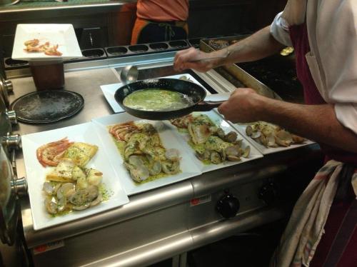 a man standing in a kitchen preparing food at Kuko Hotel - Adults Only in Oronoz-Mugaire