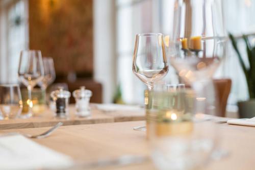 a table with wine glasses on top of it at Hotel - Restaurant De 4 Jaargetijden in Epen