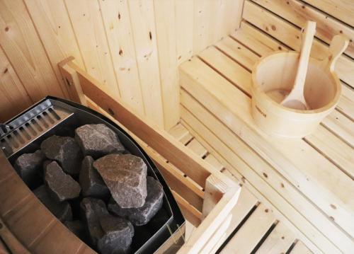 an inside view of a sauna with a toilet at Wisdom Hotel & Residence in Rayong