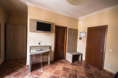 a room with a desk and a tv on the wall at Albergo Penza in Piedimonte Matese