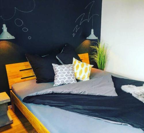 a bed with pillows on it in a bedroom at Romantische Wohnung in Bad Wörishofen in Bad Wörishofen