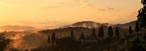 a view of a mountain with trees and a building at San Casciano - Appartamenti Podere Ianni in San Casciano in Val di Pesa