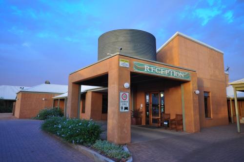 a building with a water tank on top of it at Mud Hut Motel in Coober Pedy