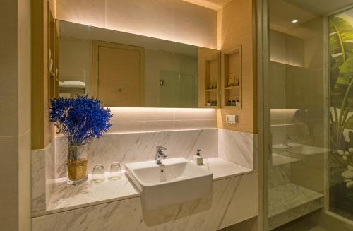 a bathroom with a sink and a mirror at Panan Krabi Resort in Ao Nang Beach