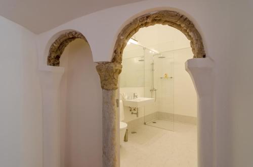 an archway in a bathroom with a sink and a shower at Casa Morgado Esporao in Évora