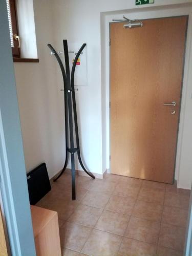 a room with a sculpture in front of a door at Penzion Dominik in Železná Ruda