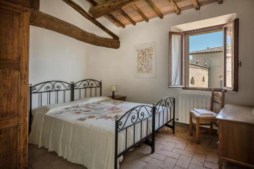 a bedroom with a bed and a window at Borgo Villa Certano - Case Vacanza in Toscana in Siena