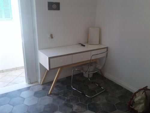 a white desk in a corner of a room at Filenia in Hydra