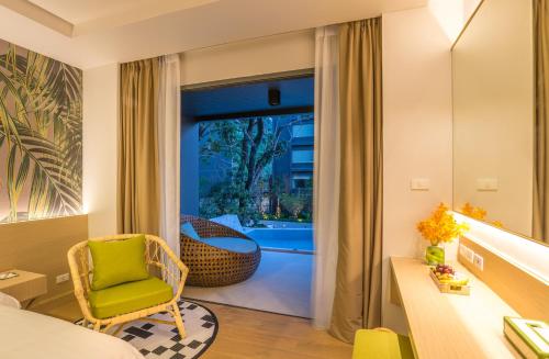 a room with a bed and a desk and a chair at Panan Krabi Resort in Ao Nang Beach