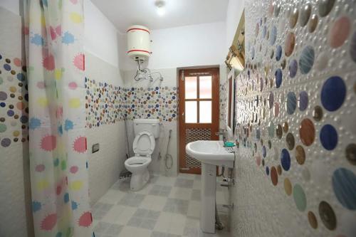 a bathroom with a toilet and a sink at Lhachik Guest House in Leh