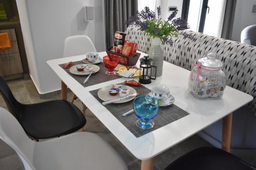 a white table with food and drinks on it at Aurum in Kamari