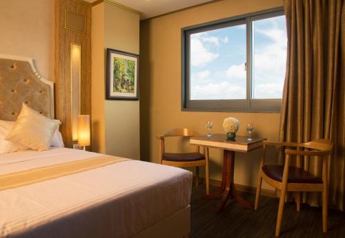 Postel nebo postele na pokoji v ubytování Appleton Boutique Hotel Mactan Cebu
