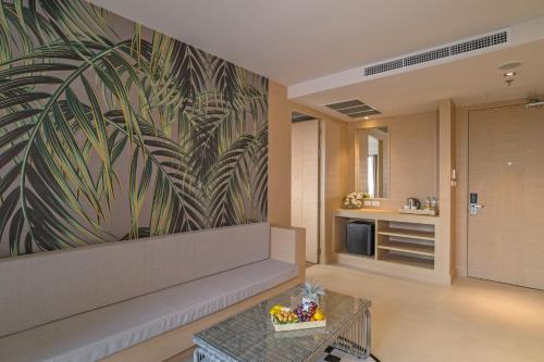 a living room with a couch and a tv at Panan Krabi Resort in Ao Nang Beach