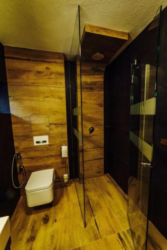 a bathroom with a toilet and a glass shower at Apartmány pod Oravským hradom in Oravský Podzámok