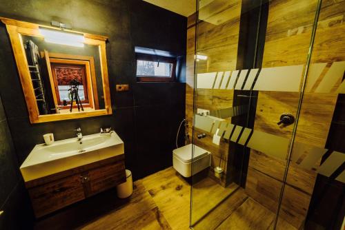 a bathroom with a sink and a glass shower at Apartmány pod Oravským hradom in Oravský Podzámok