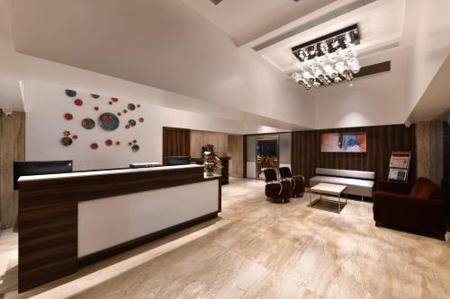 a lobby with a reception desk and a waiting room at Hotel Leafio Marigold-Near Airport in Mumbai