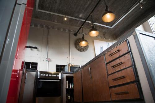 a kitchen with wooden cabinets and a clock on the wall at The Cubes in Lusaka
