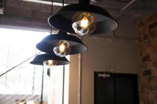 a group of lights hanging from a ceiling at The Cubes in Lusaka