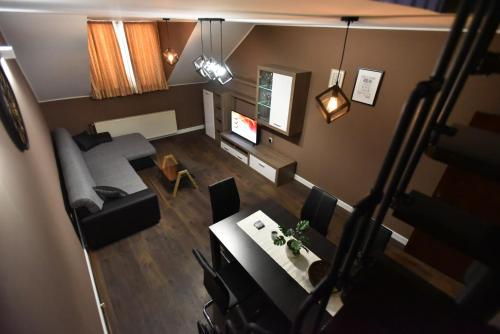 an overhead view of a living room with a couch and a table at Center Apartment Čakovec in Čakovec