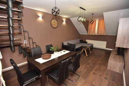 a dining room with a table and chairs at Center Apartment Čakovec in Čakovec