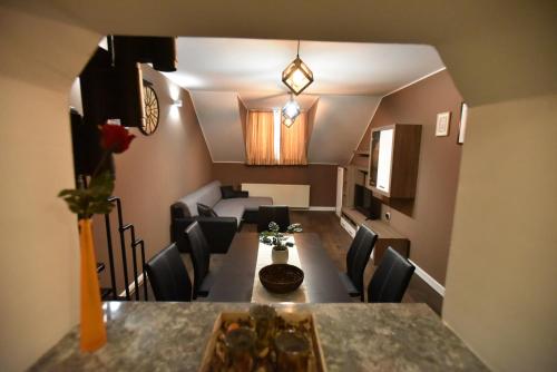 a living room with a dining room table and chairs at Center Apartment Čakovec in Čakovec