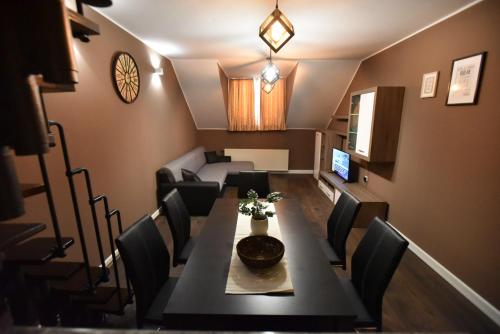 a dining room with a table and chairs at Center Apartment Čakovec in Čakovec