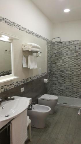 a bathroom with a sink and a toilet and a shower at Hotel La Corricella in Procida