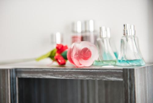 a shelf with two bottles and a flower on it at Piazza Ginnasio Affittacamere in Alghero