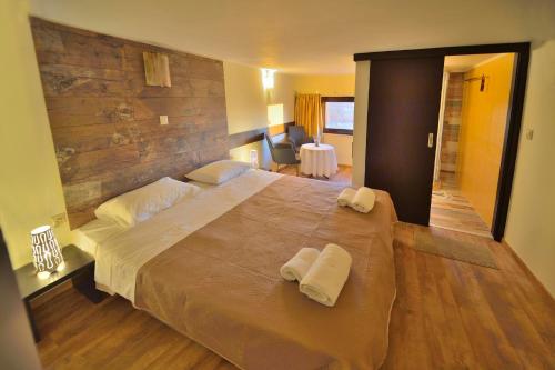 a bedroom with a large bed with towels on it at Balcony Rooms in Elafonisi
