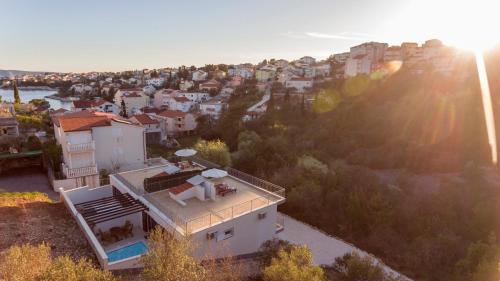 an aerial view of a house with the sun setting at Villa Palanga in Trogir
