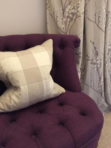a purple chair with a pillow on top of it at Glenburnie House in Oban