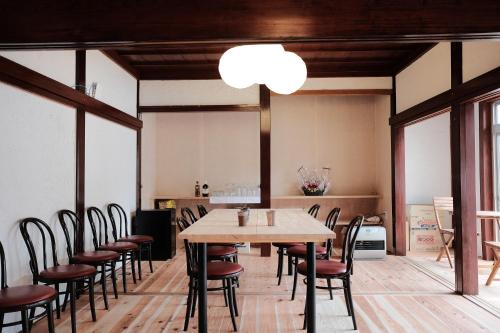 a dining room with a table and chairs at Shirakawago Guest House Kei in Shirakawa