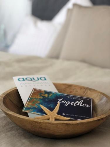 a wooden bowl with a book and a starfish at Aqua Hotel in Konstanz