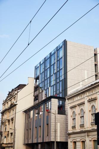 a glass building on the side of a street at Mama Shelter Belgrade in Belgrade