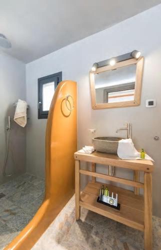 a bathroom with a sink and a mirror at Aurum in Kamari