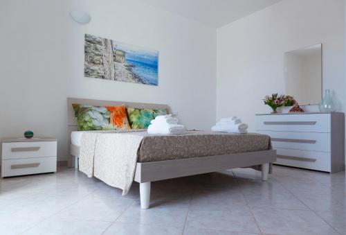 a bedroom with a bed and a dresser at Terrazza Sui Colli in Monopoli