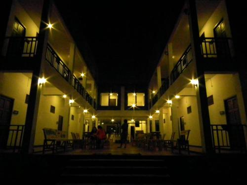 a person standing in the middle of a building at night at Norn Nab Dao Rimkhong in Chiang Khan
