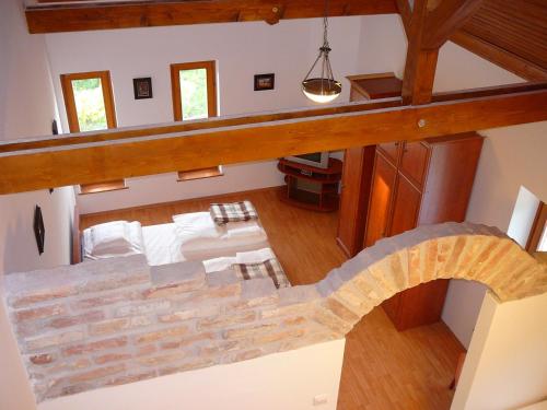 an overhead view of a bedroom with a stone wall at Almafa Apartman in Gyula