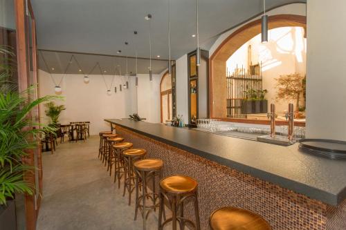 a bar with stools and a row of tables and chairs at ICON Rosetó in Palma de Mallorca