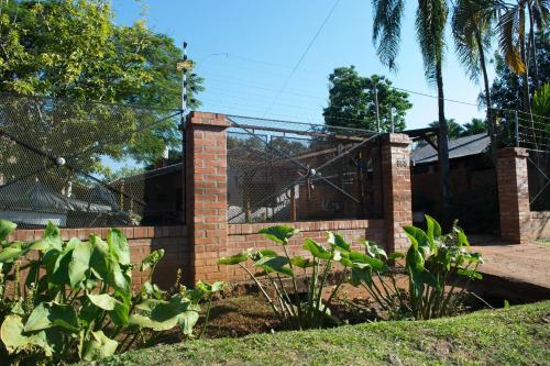 a brick fence in front of a house at Duplex Macuco in Puerto Iguazú
