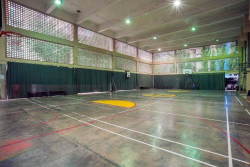 an empty gym with a basketball court in a building at YMCA International House in Mumbai