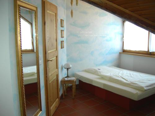 a room with a mirror and two beds in it at Hotel Goldflair am Rathaus in Korbach