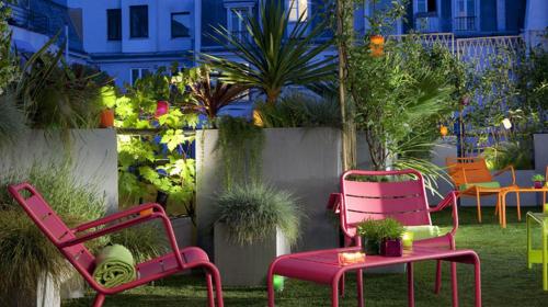 a patio with chairs and a table and plants at Le 7 Eiffel Hotel by Malone in Paris